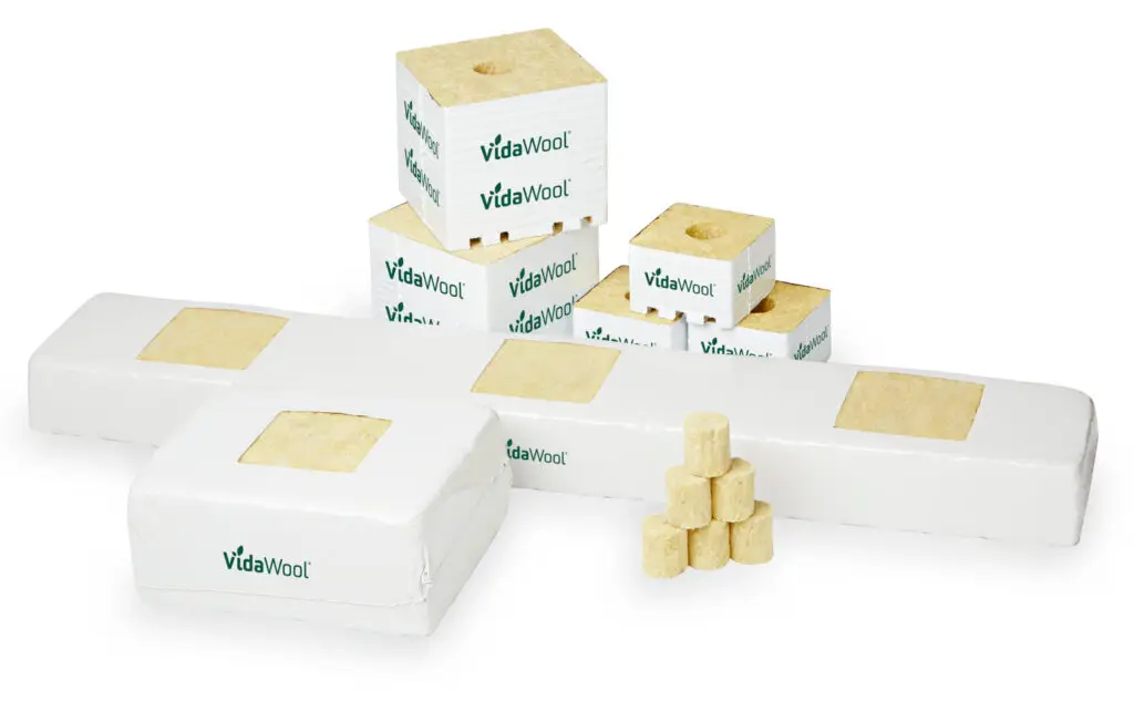 Three sizes of rockwool growing media: 1.5-inch starter plug, 4-inch veg block, and 6-inch production block side by side